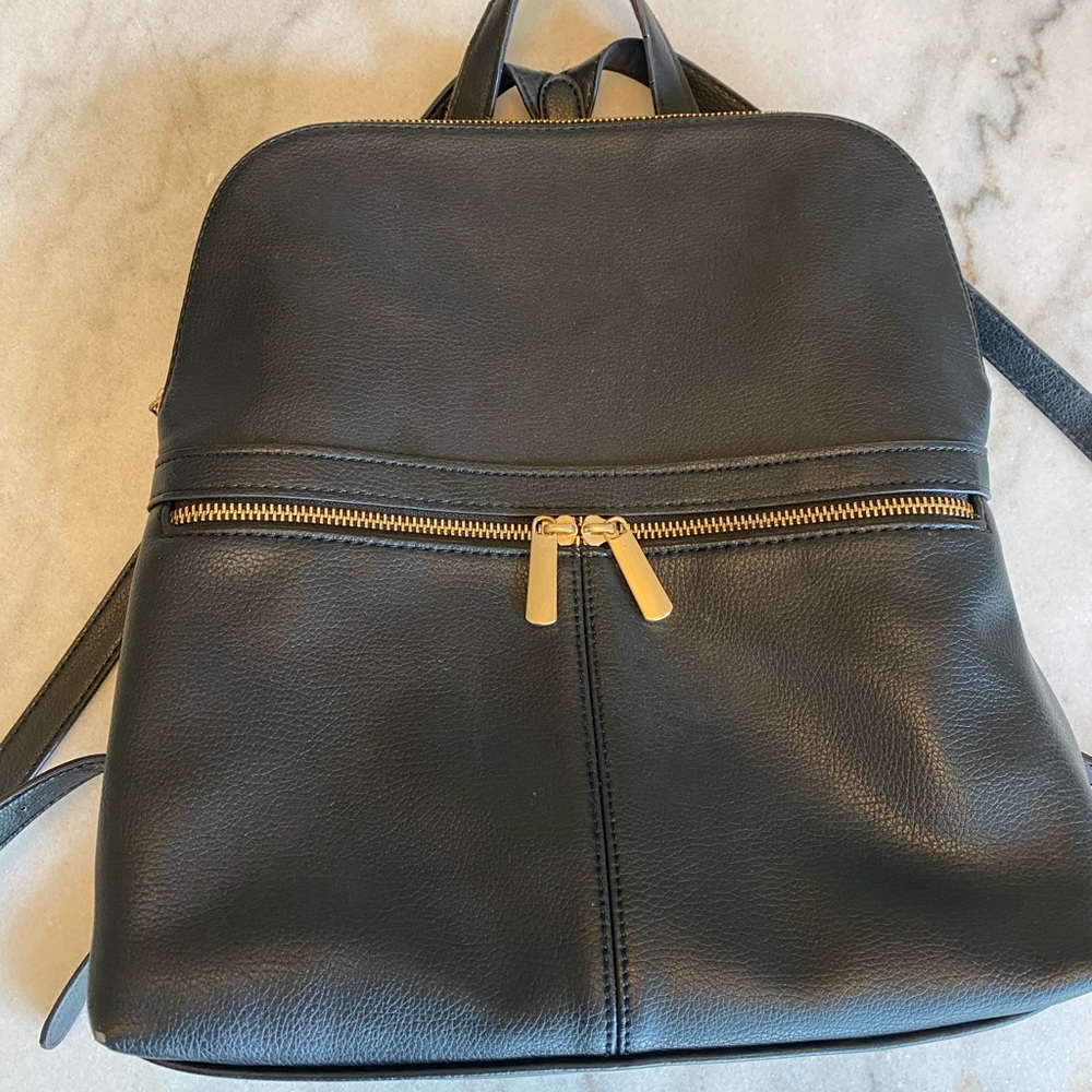 Black backpack with gold zippers